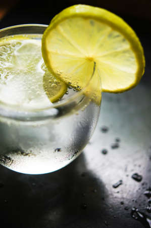 Glasses of water with fresh lime on the rustic table
