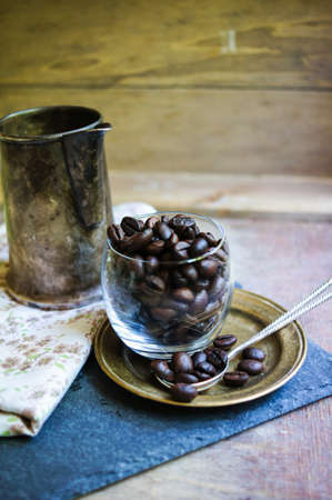 Coffee beans and vintage cups on the old tableの写真素材