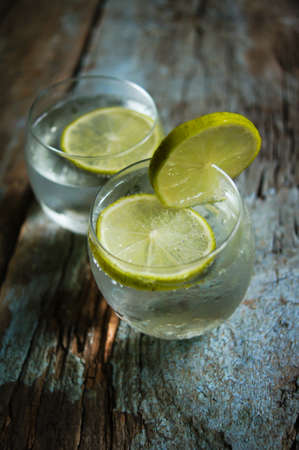 Glasses of water with fresh lime on the rustic tableの写真素材