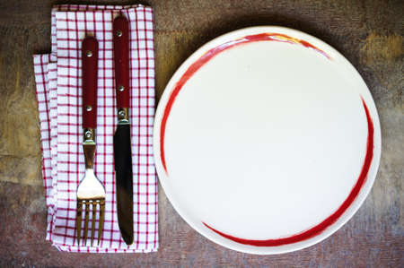 Table Setting with napkin and silverware on wooden tableの写真素材