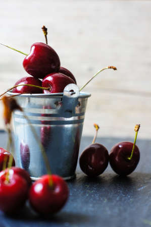 ripe sweet cherries in a bowl on a bright napkinの写真素材
