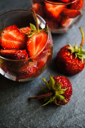 Fresh strawberries in the glasses as a dessert on rustic style tableの写真素材