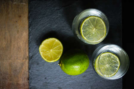 Glasses of water with fresh lime on the rustic tableの写真素材