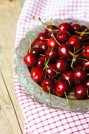 ripe sweet cherries in a bowl on a bright napkin