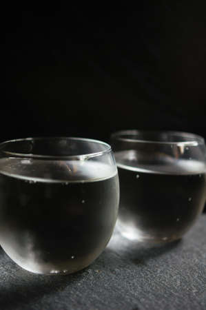 Glasses of water with fresh lime on the rustic tableの写真素材