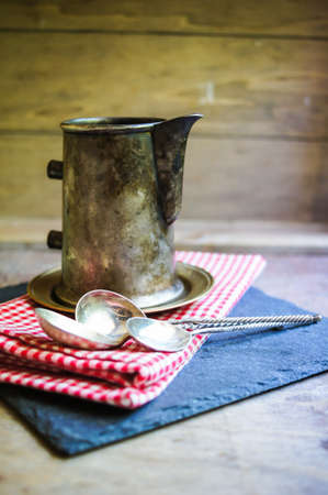Coffee beans and vintage cups on the old table