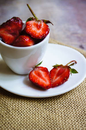 Fresh strawberries in the glasses as a dessert on rustic style tableの写真素材