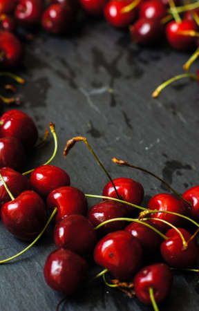 ripe sweet cherries in a bowl on a bright napkinの写真素材