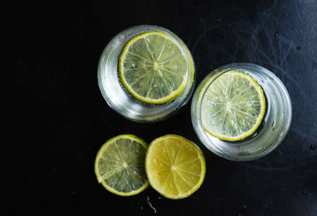 Glasses of water with fresh lime on the rustic tableの写真素材
