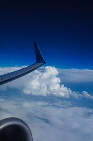 View from airplane window with blue sky and white cloudsの写真素材