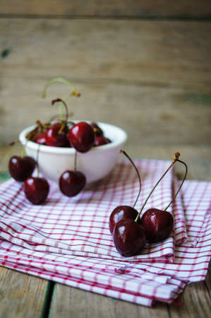 Red sweet cherries in the white bowlの写真素材