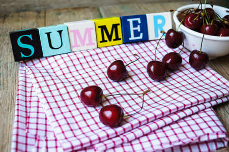 Red sweet cherries in the white bowlの写真素材