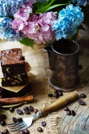 Home made brownies on vintage plate with vintage silverware and hydrangea flowersの写真素材