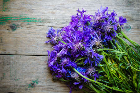 Cornflowers on the old wooden table, rusticの写真素材