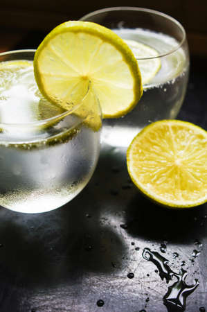 Glasses of water with fresh lime on the rustic tableの写真素材