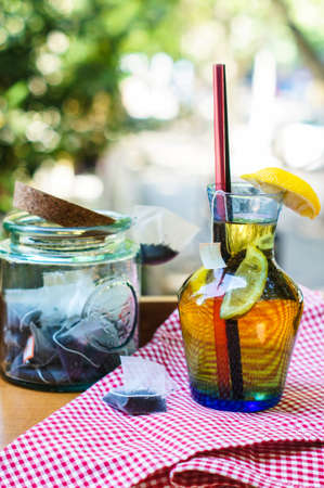 Glass of cold tea with lemon outdoorの写真素材