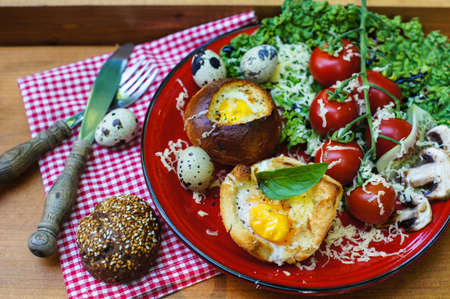 Healthy Egg in a Basket with fresh vegetable salad for dinnerの写真素材