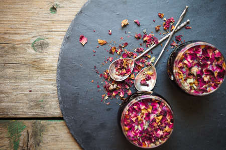 Rose bud tea in the vintage spoons on the black stone desk