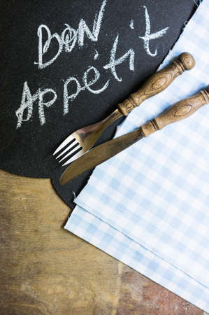 Table Setting with napkin and silverware on wooden tableの写真素材