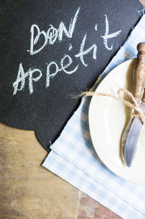 Table Setting with napkin and silverware on wooden tableの写真素材