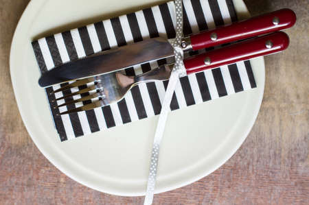 Table Setting with napkin and silverware on wooden tableの写真素材