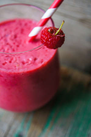 Glass with rasberry smoothie on the table, Selective focusの写真素材