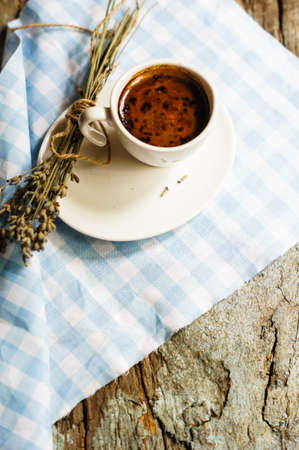 cup of black coffee with chocolate macaroon and lavender flowersの写真素材