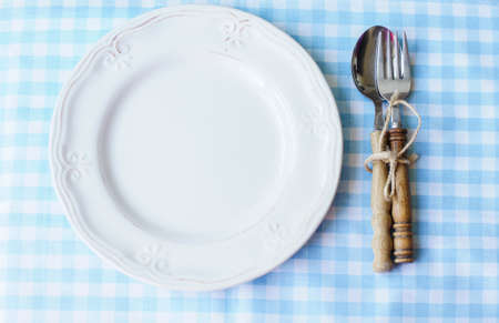 Table Setting with napkin and silverware on wooden tableの写真素材