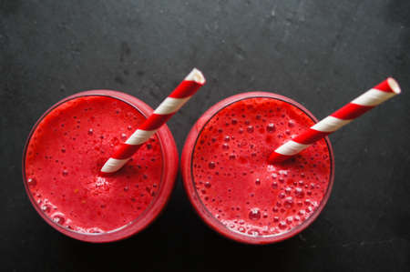 Glass with rasberry smoothie on the table, Selective focus