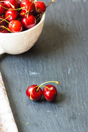 ripe sweet cherries in a bowl on a bright napkin