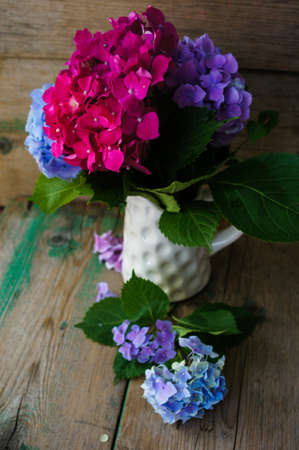 Pastel color hydrangea flowers on wooden tableの写真素材
