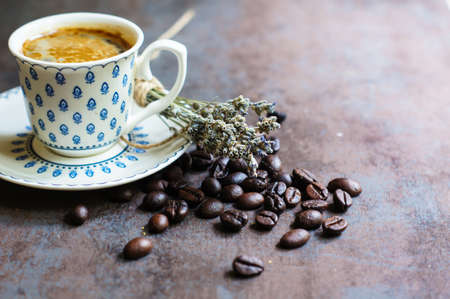 Vintage cup with black coffee, dry lavender flowers and coffee beansの写真素材