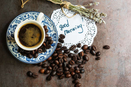 Vintage cup with black coffee, dry lavender flowers and coffee beansの写真素材