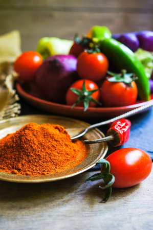 Ripe fresh vegetable cherry tomatoes, bell and chilli peppers, onion and pepper spices, rustic...