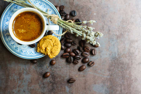Vintage cup with black coffee, dry lavender flowers and coffee beansの写真素材