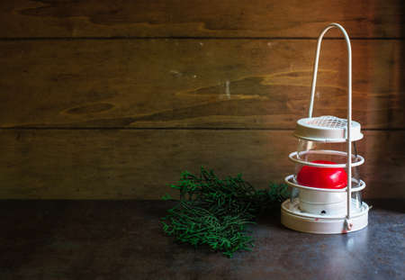 Christmas time, vintage lam with red candle and Fir Tree. Selective focusの写真素材