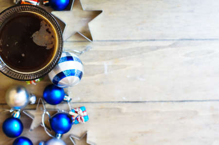 Glass of coffee and christmas time festive decoration on the dark backgroundの写真素材