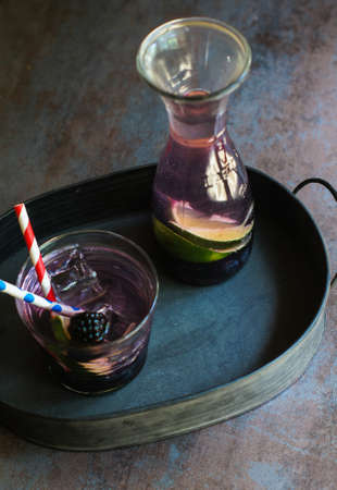 Lemonade with fresh berries and lime, vintage style. Selective focus