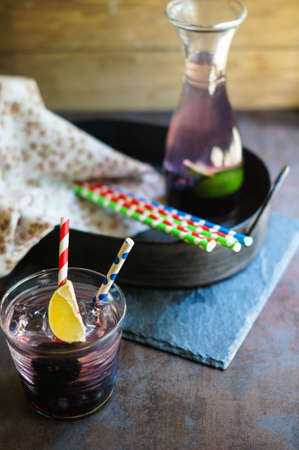 Lemonade with fresh berries and lime, vintage style. Selective focusの写真素材