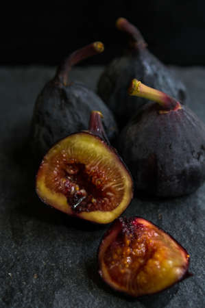 Ripe fig fruits on the dark vintage background. Selective focus