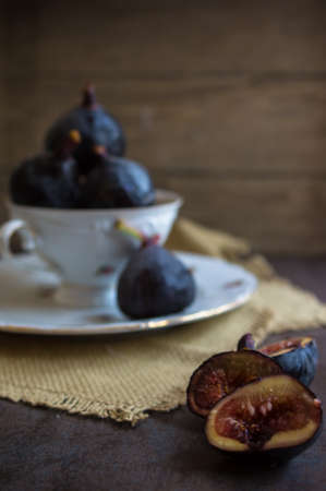 Ripe fig fruits on the dark vintage background. Selective focus