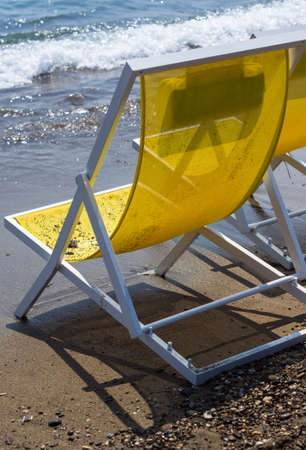 Bright colors sun chairs on the sand beach of Mediterranean seaの写真素材