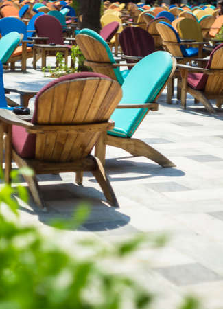 Wooden sun chair on outdoor deck cafe overlooking the Mediterranean Seaの写真素材