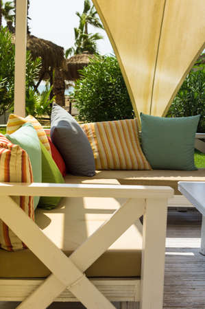 Wooden sun chair on outdoor deck cafe overlooking the Mediterranean Seaの写真素材
