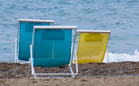 Bright colors sun chairs on the sand beach of Mediterranean seaの写真素材