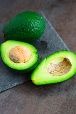 avocado on a dark wood background. tinting. selective focus