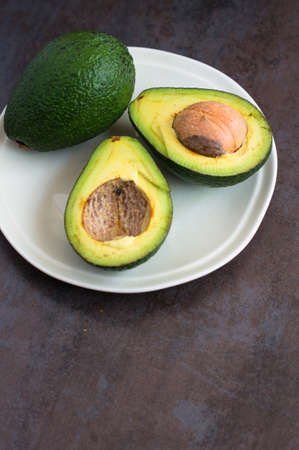avocado on a dark wood background. tinting. selective focus