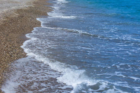 Yellow sand beach and sea wavesの写真素材