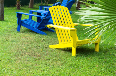 Bright color wooden sun chairs in the beach gardenの写真素材