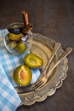 Sweet plum dessert with cinnamon in vintage styleの写真素材